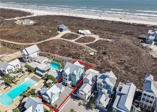 birds eye view of property featuring a water view and a view of the beach