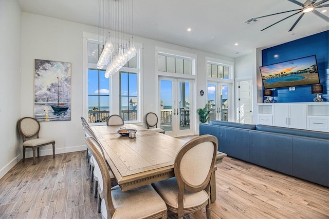 dining area featuring french doors, plenty of natural light, baseboards, and wood finished floors