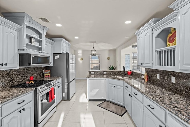 8230 Excalibur, Corpus Christi, TX 78414 - kitchen with open shelves, stainless steel appliances, a peninsula, decorative backsplash, and light tile patterned floors