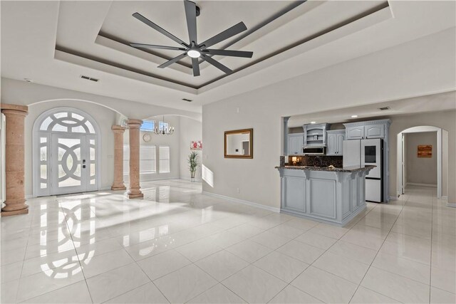 8230 Excalibur, Corpus Christi, TX 78414 - entrance foyer featuring decorative columns, light tile patterned flooring, a raised ceiling, arched walkways, and ceiling fan