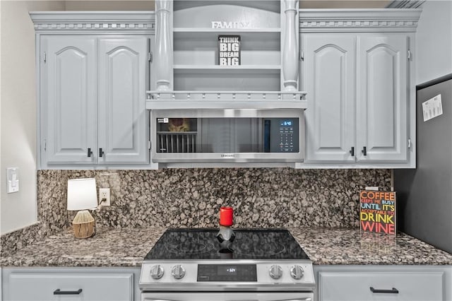 8230 Excalibur, Corpus Christi, TX 78414 - kitchen with appliances with stainless steel finishes, tasteful backsplash, white cabinets, and dark stone counters