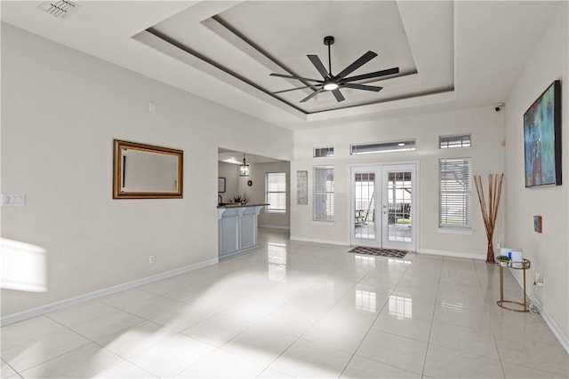 8230 Excalibur, Corpus Christi, TX 78414 - unfurnished room with a tray ceiling, ceiling fan, french doors, and light tile patterned floors