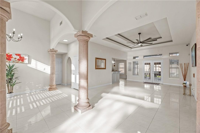 8230 Excalibur, Corpus Christi, TX 78414 - unfurnished living room featuring decorative columns, light tile patterned floors, arched walkways, and ceiling fan