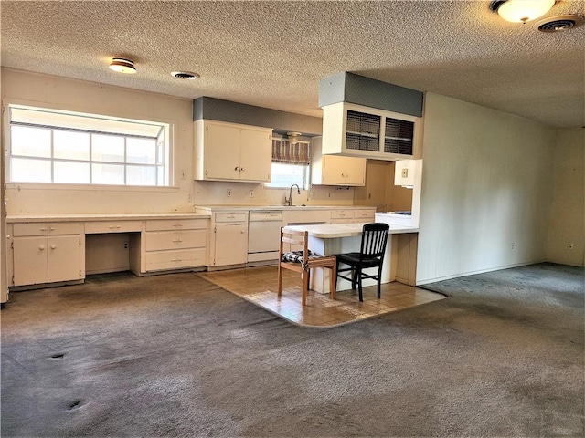 128 Granby Pl, Portland, TX 78374 - kitchen featuring white dishwasher, dark carpet, a textured ceiling, light countertops, and a sink