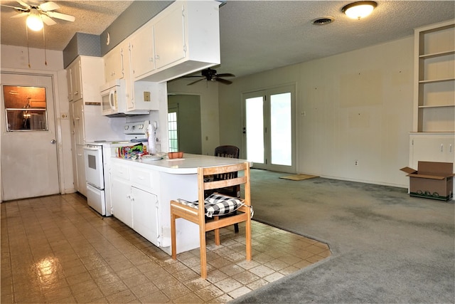 kitchen with light carpet, ceiling fan, a textured ceiling, white appliances, and white cabinets