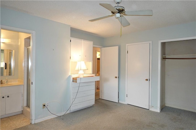 128 Granby Pl, Portland, TX 78374 - unfurnished bedroom featuring light carpet, baseboards, ensuite bath, a sink, and a ceiling fan