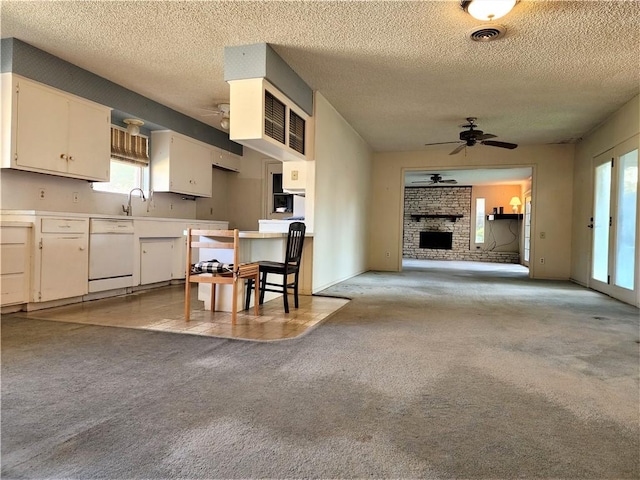 128 Granby Pl, Portland, TX 78374 - kitchen featuring white dishwasher, a ceiling fan, light colored carpet, healthy amount of natural light, and a textured ceiling