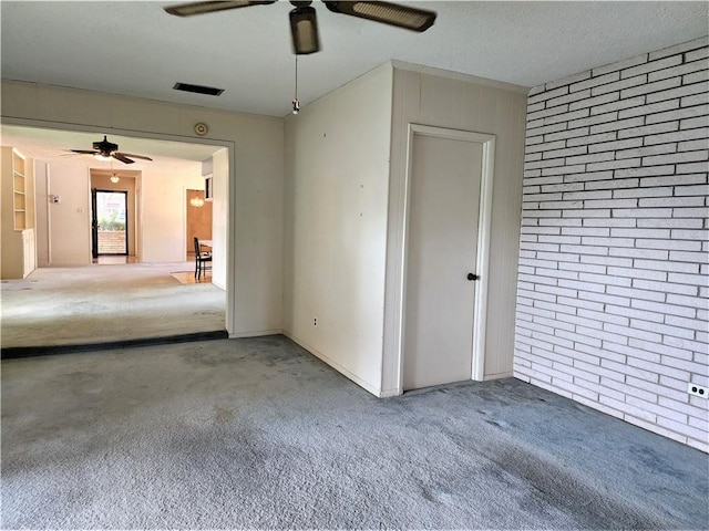 128 Granby Pl, Portland, TX 78374 - spare room featuring ceiling fan, carpet flooring, and brick wall