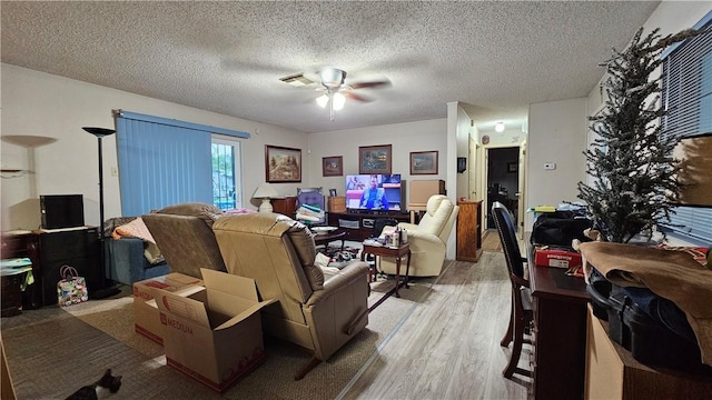 10200 Shane Dr, Corpus Christi, TX 78410 - living room featuring light wood-style floors, a ceiling fan, and a textured ceiling