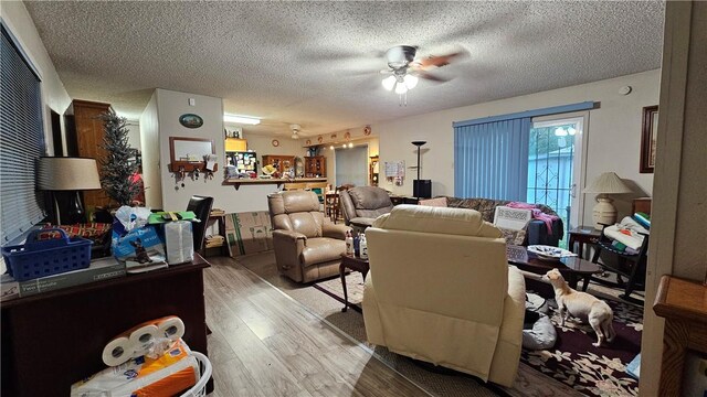 10200 Shane Dr, Corpus Christi, TX 78410 - living room featuring wood finished floors, a ceiling fan, and a textured ceiling