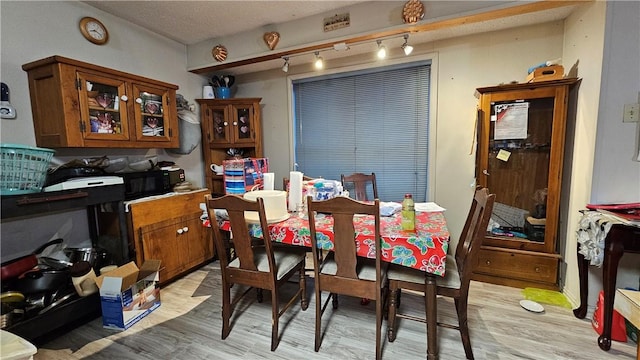 10200 Shane Dr, Corpus Christi, TX 78410 - dining room featuring track lighting and light wood-type flooring