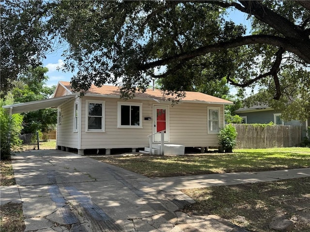 624 E Kenedy Ave, Kingsville, TX 78363 - view of front of house with concrete driveway and a carport