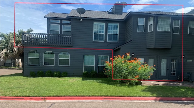 exterior space featuring a front yard and french doors