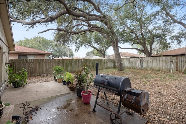 view of patio / terrace featuring a fenced backyard and a grill