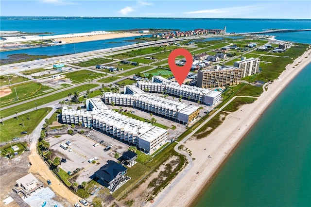 birds eye view of property featuring a beach view and a water view