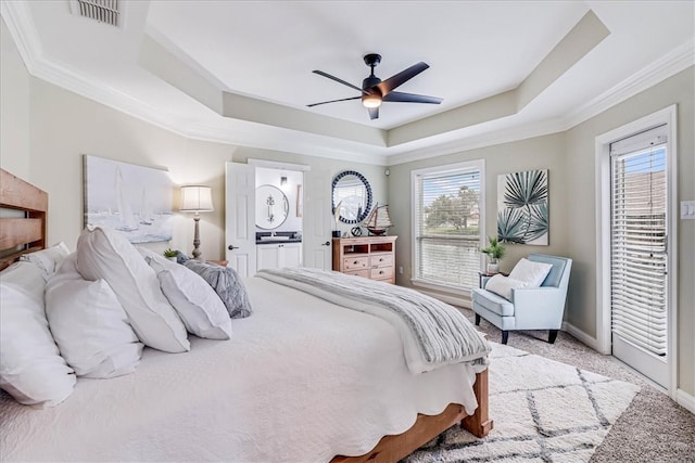 carpeted bedroom featuring multiple windows, ceiling fan, connected bathroom, and crown molding