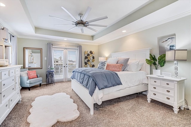 bedroom featuring a raised ceiling, light carpet, ceiling fan, and access to exterior