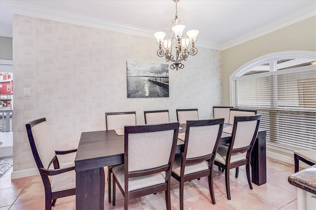 dining area with ornamental molding, light tile patterned flooring, and an inviting chandelier