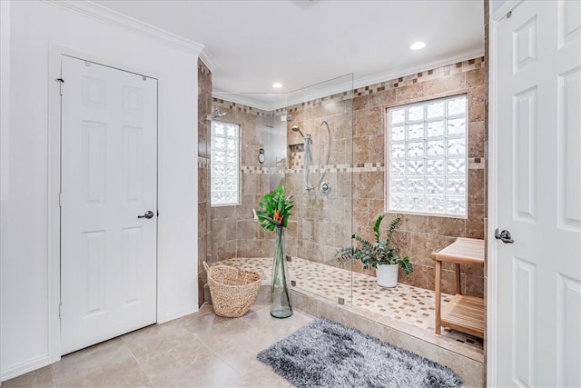 bathroom with tile walls, tile patterned floors, tiled shower, and crown molding