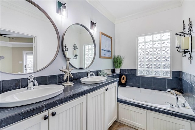 bathroom featuring vanity, a bathtub, and crown molding