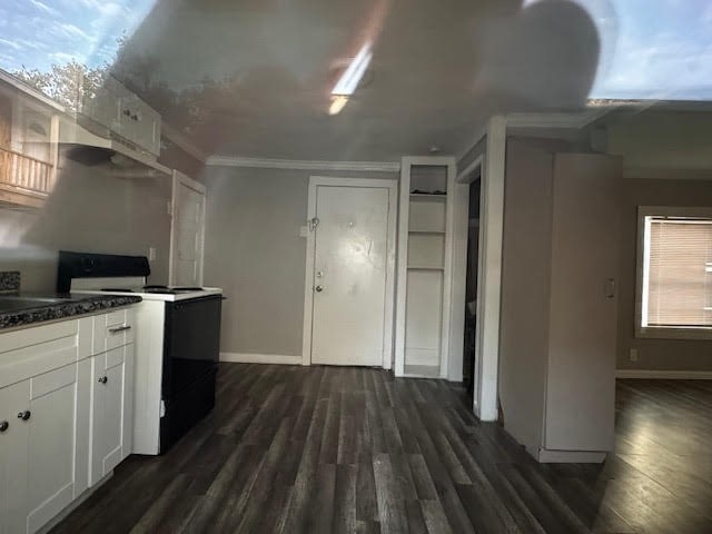 kitchen with dark hardwood / wood-style flooring, white cabinets, ornamental molding, and white range with electric cooktop