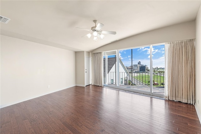 unfurnished room with dark hardwood / wood-style flooring, vaulted ceiling, and ceiling fan