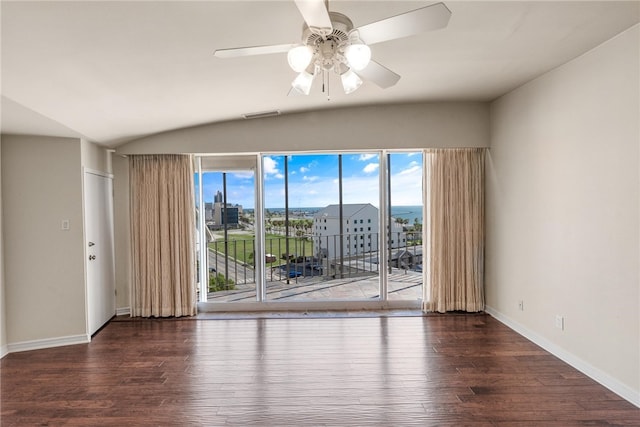 spare room with ceiling fan, dark hardwood / wood-style flooring, and vaulted ceiling