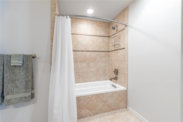 bathroom featuring shower / bath combination with curtain and tile patterned flooring