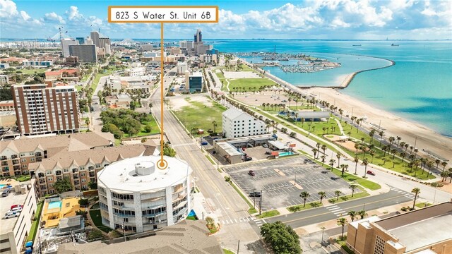 drone / aerial view featuring a water view and a beach view