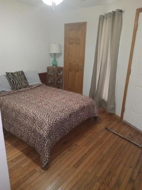 bedroom featuring wood-type flooring and ceiling fan