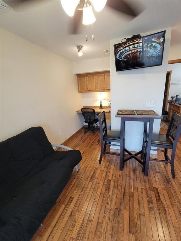 dining area with ceiling fan and light hardwood / wood-style floors