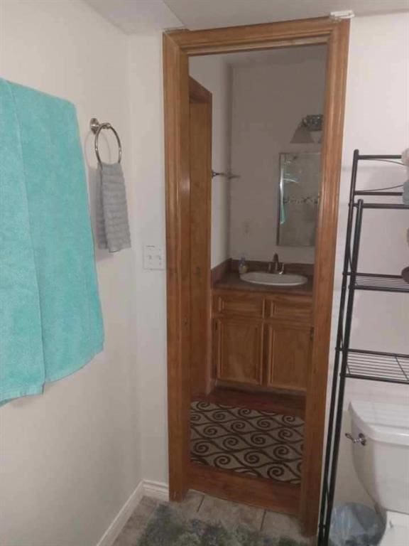 bathroom with tile patterned floors, vanity, and toilet