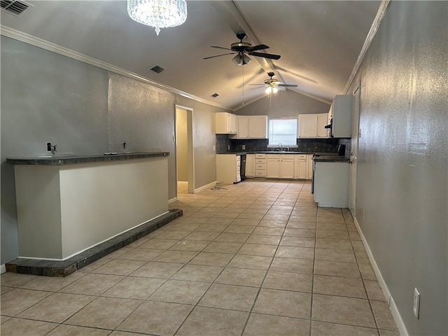 1705 Sherman St, Corpus Christi, TX 78416 - kitchen with ceiling fan, vaulted ceiling, ornamental molding, range, and white cabinetry