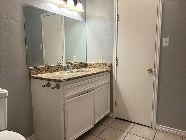 1705 Sherman St, Corpus Christi, TX 78416 - bathroom with tile patterned floors, vanity, and a textured wall