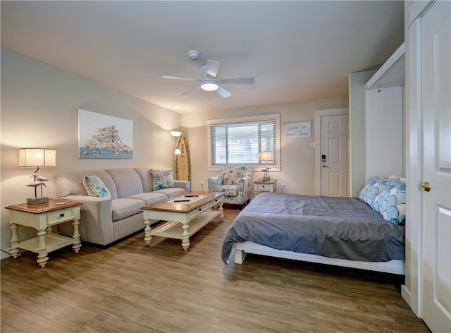 bedroom with hardwood / wood-style flooring and ceiling fan