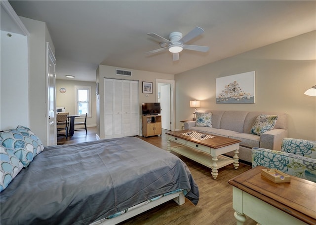 bedroom featuring hardwood / wood-style floors, ceiling fan, and a closet