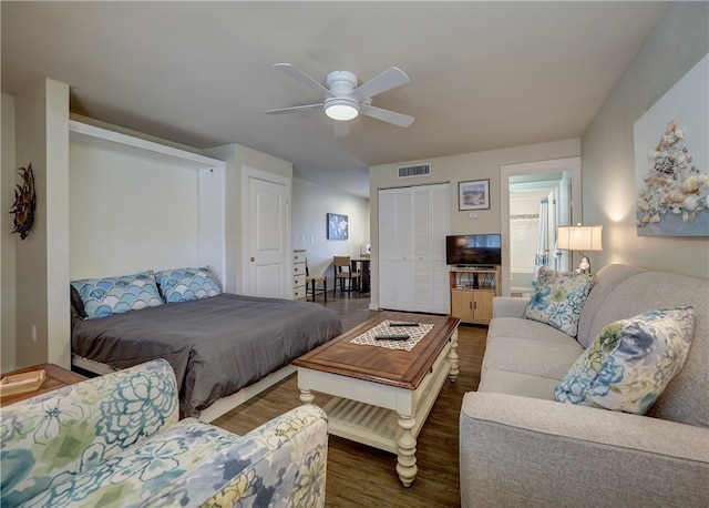 bedroom with ceiling fan and dark hardwood / wood-style floors