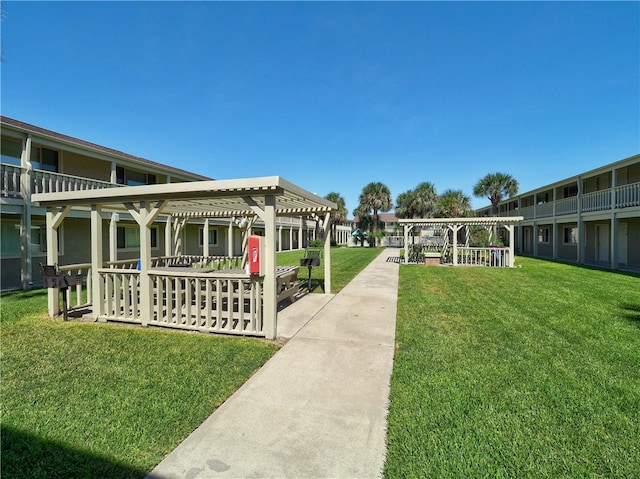 view of yard with a pergola and a balcony