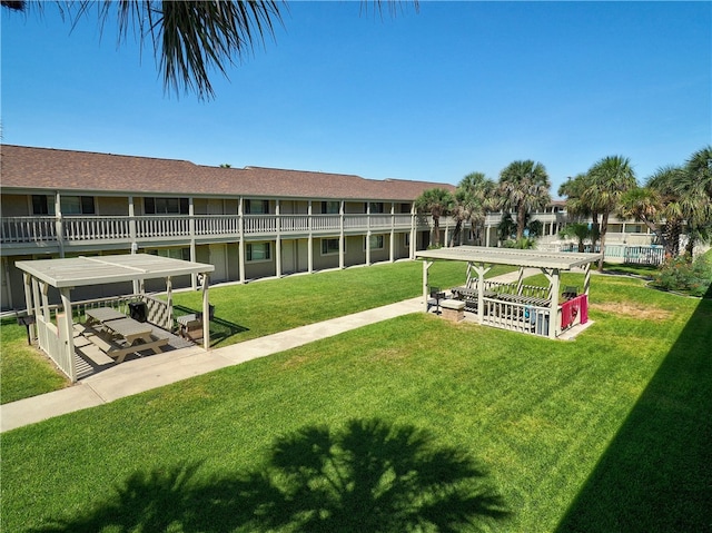 view of property's community with a lawn