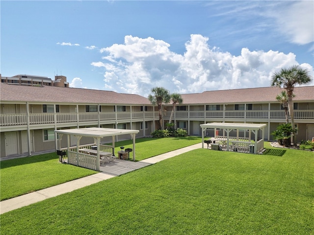 view of property's community with a lawn