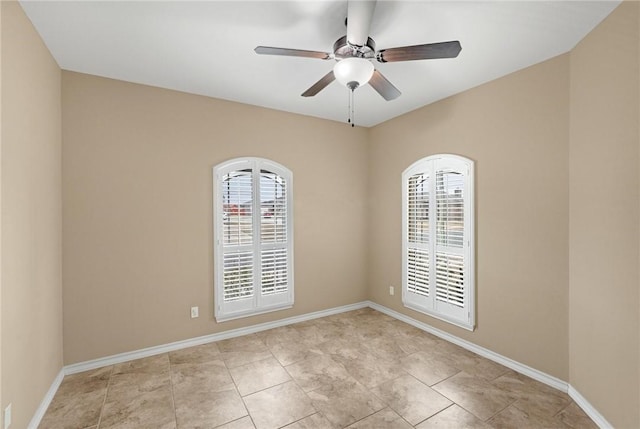 empty room with light tile patterned floors and ceiling fan