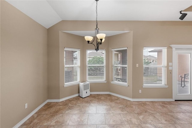 unfurnished dining area featuring a chandelier, light tile patterned floors, lofted ceiling, and baseboards