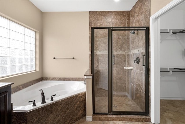 bathroom with vanity, a wealth of natural light, and shower with separate bathtub