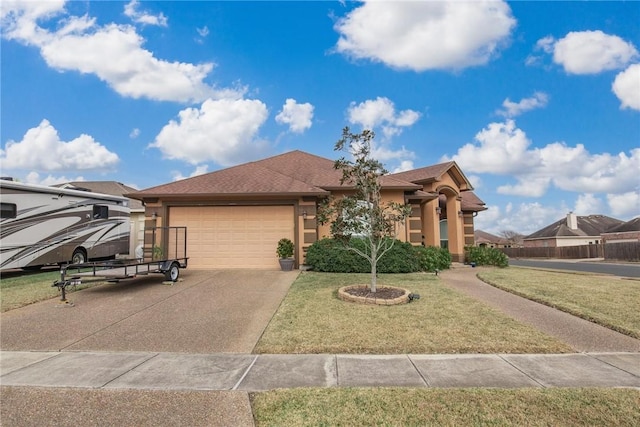 view of front of house featuring a garage and a front lawn