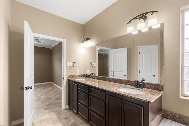 bathroom featuring crown molding and vanity