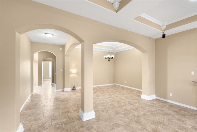 interior space featuring baseboards, arched walkways, and crown molding