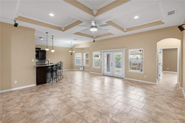 unfurnished living room featuring sink, coffered ceiling, ornamental molding, ceiling fan with notable chandelier, and beamed ceiling