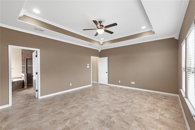 spare room with visible vents, crown molding, baseboards, a raised ceiling, and a ceiling fan