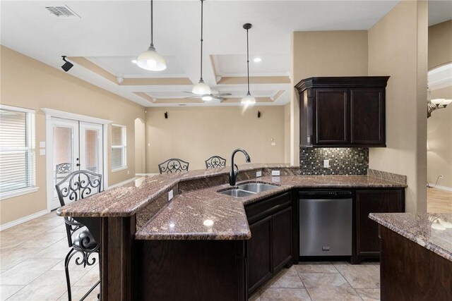 kitchen with sink, a kitchen breakfast bar, coffered ceiling, stainless steel dishwasher, and french doors