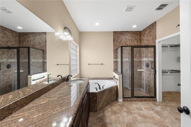 bathroom featuring plus walk in shower and vanity